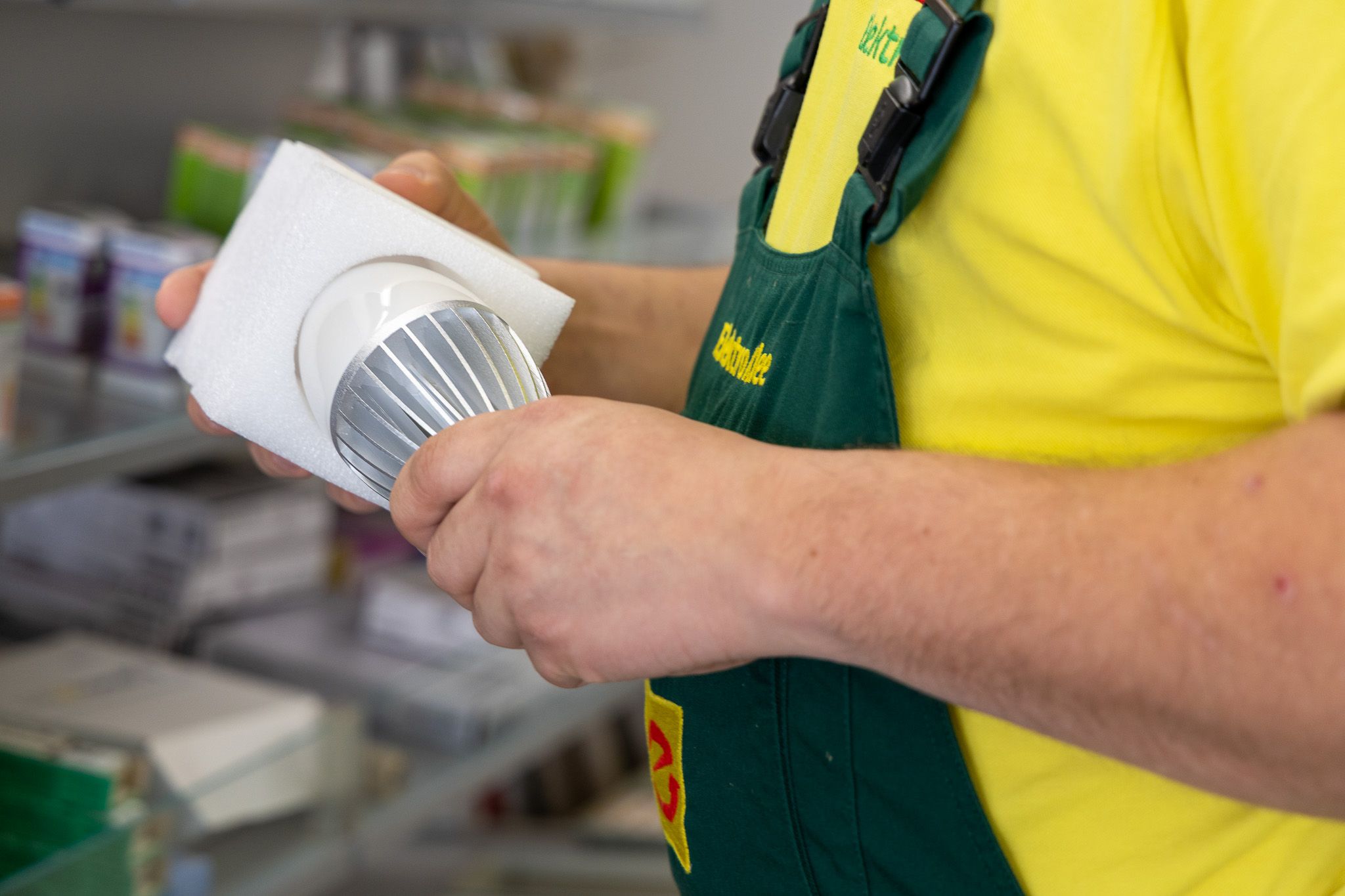 Elektro Klee Mitarbeiter hält einen Sensor für Sicherheitstechnik und Gebäudetechnik